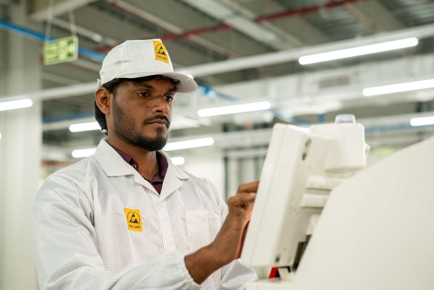 Industrial worker in a hard hat reviewing production notes