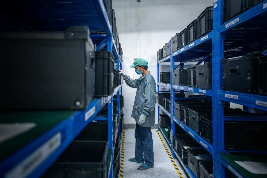 Warehouse aisle with industrial worker