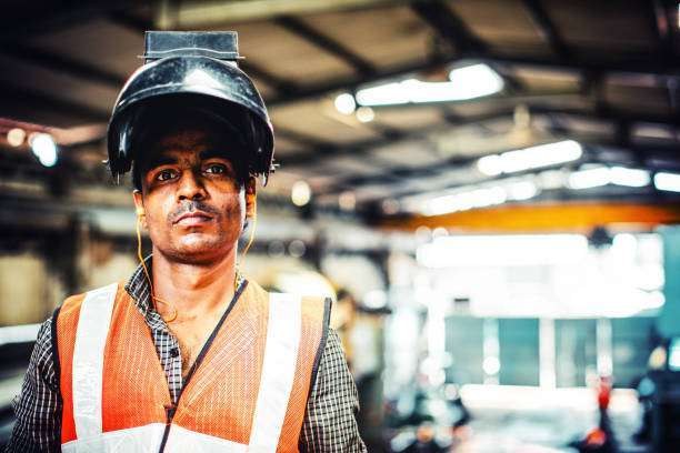Industrial headshot of a worker in safety gear